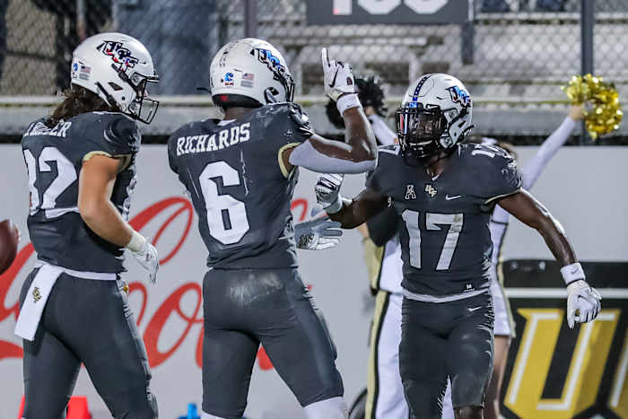 Nov 20, 2021; Orlando, Florida, USA; UCF Knights wide receiver Amari Johnson (17) celebrates his touchdown with running back Mark-Antony Richards (6) and tight end Alec Holler (82) against the Connecticut Huskies during the second half at Bounce House.